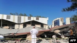 This handout picture released by the Tamaulipas Civil Protection shows a priest looking at the site where people were trapped after a church roof collapsed in Ciudad Madero, Tamaulipas State, Mexico, on Oct. 1, 2023.