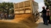 Farmers dump a pile of rice on the ground during a rally, outside a Bank for Agriculture and Agricultural Cooperatives in Bangkok, March 11, 2014.