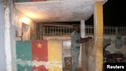 FILE - A security forces member stands guard at prison in Yaounde, Cameroon, Sept. 1, 2017.