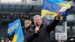 Mantan Presiden Ukraina Petro Poroshenko menyapa para pendukungnya saat ia tiba di Bandara Internasional Zhuliany di Kyiv, pada 17 Januari 2022. (Foto: AP/Efrem Lukatsky)