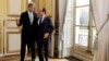 U.S. Secretary of State John Kerry (L) walks with French President Francois Hollande after their meeting at Elysee Palace in Paris, Feb. 27, 2013.