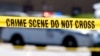Yellow crime tape blocks off an area where two Baltimore city police officers were shot and a suspect was killed, July 13, 2021, in Baltimore, Maryland. 