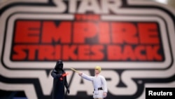 FILE - Vintage action figures of Star Wars characters Darth Vader (L) and Luke Skywalker stand on a table ahead of an auction of Star Wars and film related toys at the Vectis auction house in Stockton-on-Tees, Britain, Nov. 23, 2015.