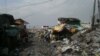 Junk shops line this intersection where scavengers drop off and haul away bags of recyclable material at the Smokey Mountain dump site, Manila Bay, Philippines, Dec. 12, 2013. (Simone Orendain for VOA) 