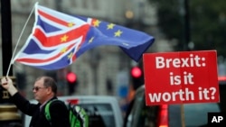 An anti-Brexit poster is seen in front of the Houses of Parliament in London, Sept. 4, 2018. 