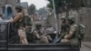 Des membres du M23 en patrouille dans les rues de Goma en RDC.