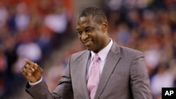 FILE - Former NBA player Dikembe Mutumbo reacts on the court during the second half of the NCAA Final Four college basketball tournament championship game between Wisconsin and Duke, April 6, 2015, in Indianapolis. 