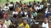 Refugee children from the Democratic Republic of Congo attend class in a forest near the town of Gangania, more than 850 km north of Brazzaville, the capital of neighboring Congo, 25 Feb 2010