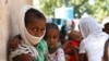 Refugees from the Tigray region of Ethiopia wait to register at the UNCHR center at Hamdayet, Sudan, Nov. 14, 2020. Ethiopia’s defiant Tigray regional government has fired rockets at two airports in the neighboring Amhara region.