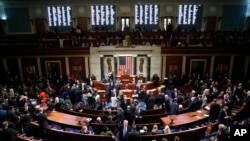 FILE - House members vote on a resolution to move forward with procedures for the next phase of the impeachment inquiry into President Donald Trump, in the House chamber on Capitol Hill in Washington, Oct. 31, 2019.