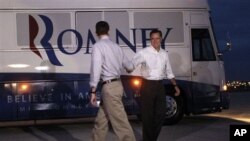 Republican presidential candidate, former Massachusetts Governor Mitt Romney, and vice presidential running mate Rep. Paul Ryan, R-Wisconsin, shake hands as they part ways at the airport, August 12, 2012 in Milwaukee. (AP)