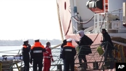 People disembark from the Ocean Viking rescue ship, at the Taranto harbor, Southern Italy, Jan. 29, 2020.