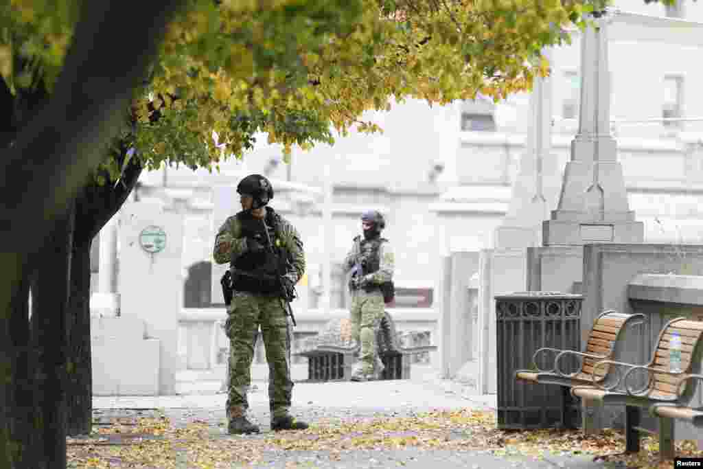 Police officers stand guard near the National War Memorial in downtown Ottawa, Oct. 23, 2014.