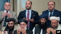 Taliban political chief Sher Mohammad Abbas Stanikzai, first row second from left, Abdul Salam Hanafi and other Taliban official pray during the "intra-Afghan" talks in Moscow, Russia, Wednesday, Feb. 6, 2019. The U.S. has promised to withdraw half…