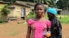 A girl returns from a community meeting with Guinea's prime minister, Mohamed Said Fofana, in Forecariah on Sept. 26, 2014. (Carol Guensburg/VOA)