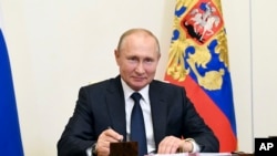 Russian President Vladimir Putin attends a meeting via teleconference at the Novo-Ogaryovo residence outside Moscow, June 1, 2020.