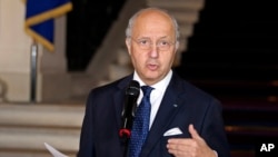 FILE - French Foreign Minister Laurent Fabius, describing a world where floods, desertification and droughts will intensify conflicts, calls climate change "a threat to peace."