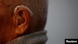 FILE - An 85-year-old Nepalese man is seen fitted with a hearing aid, in Kathmandu, Nepal, April 12, 2017.