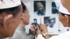 A group of Muslim men point to former Khmer Rouge leader Duch while touring the Tuol Sleng museum. 