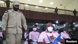 FILE - Paul Rusesabagina, portrayed as a hero in a Hollywood movie about Rwanda's 1994 genocide, sits inside the courtroom in Kigali, Rwanda, Feb. 17, 2021. 
