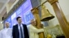 Serge Pun, right, executive chairman of First Myanmar Investment, joyfully hugs a bell pillar as electronic trading commence listing his company during the opening day of trading at Yangon Stock Exchange in Yangon, Myanmar, March 25, 2016. 