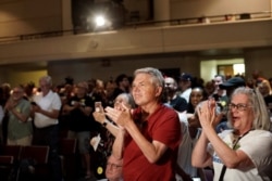 Attendees applaud while U.S. Representatives Ilhan Omar (D-MN) and Pramila Jayapal (D-WA) host a town hall meeting on 'Medicare For All' in Minneapolis, Minnesota, July 18, 2019.