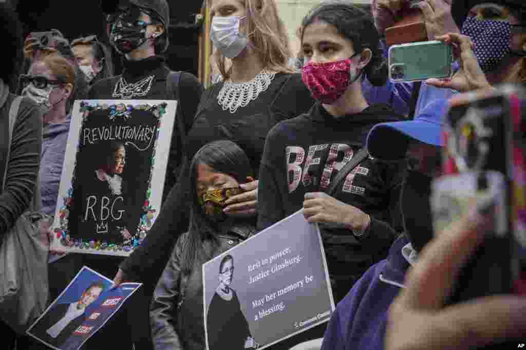 People gather during a public remembrance to honor the life and legacy of U.S. Supreme Court Justice and former Brooklynite Ruth Bader Ginsburg, outside Brooklyn's, Municipal Building, New York, Sept. 20, 2020.