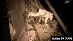 Astronaut Scott Kelly makes an inspection on the International Space Station, Nov. 6, 2015. 